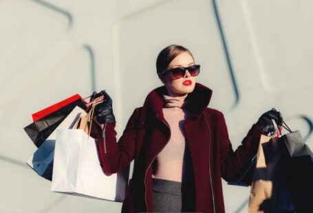 Fashion - photo of woman holding white and black paper bags