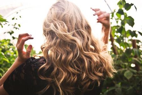 Fashion Highlights - Blonde-haired Woman Standing Between Green Plants